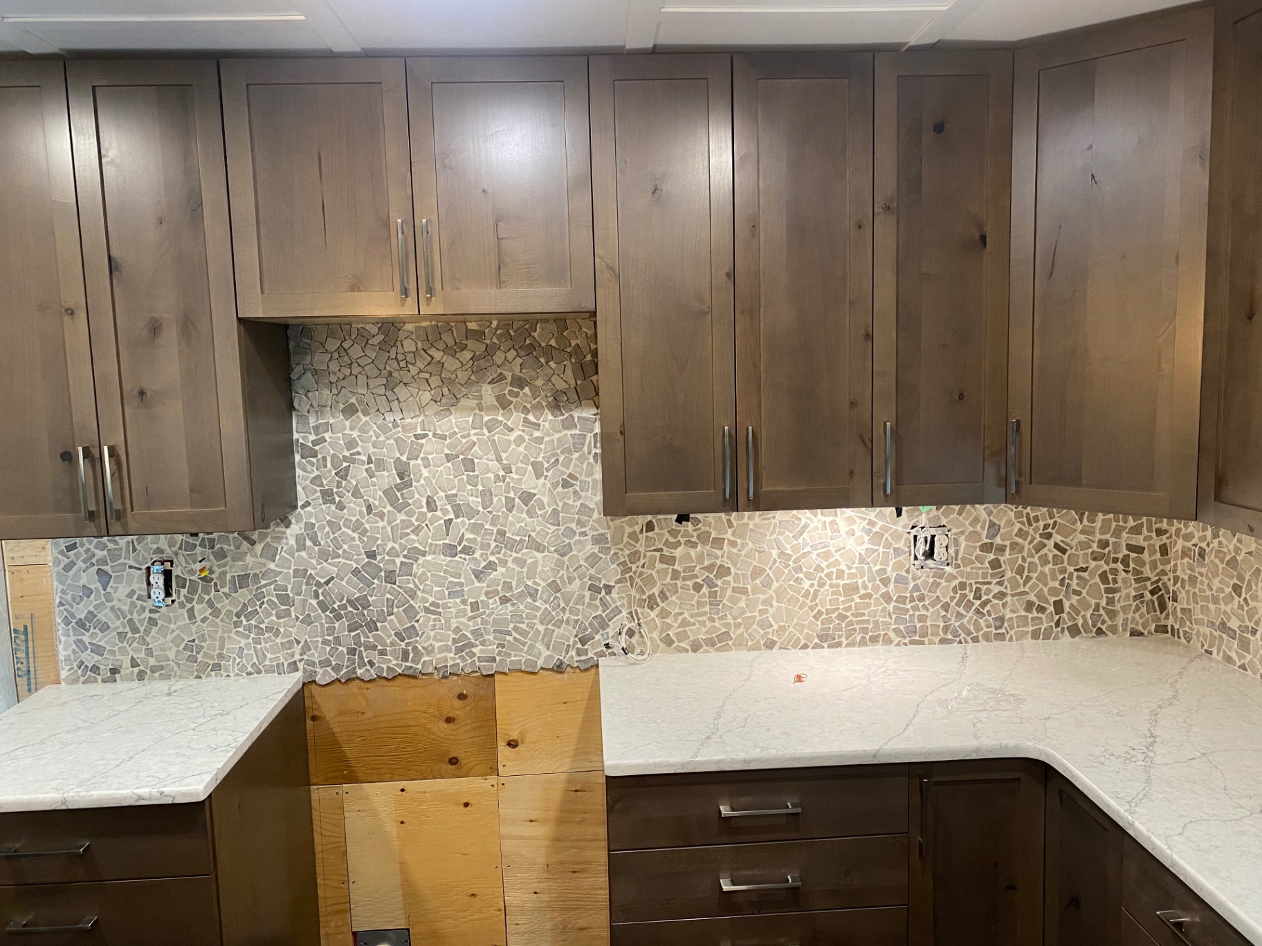 Natural stone tile backsplash installed in a kitchen